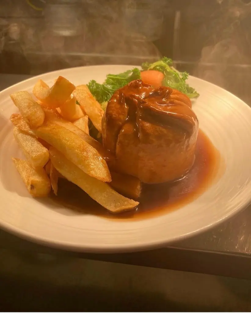 A pie with chips and greens